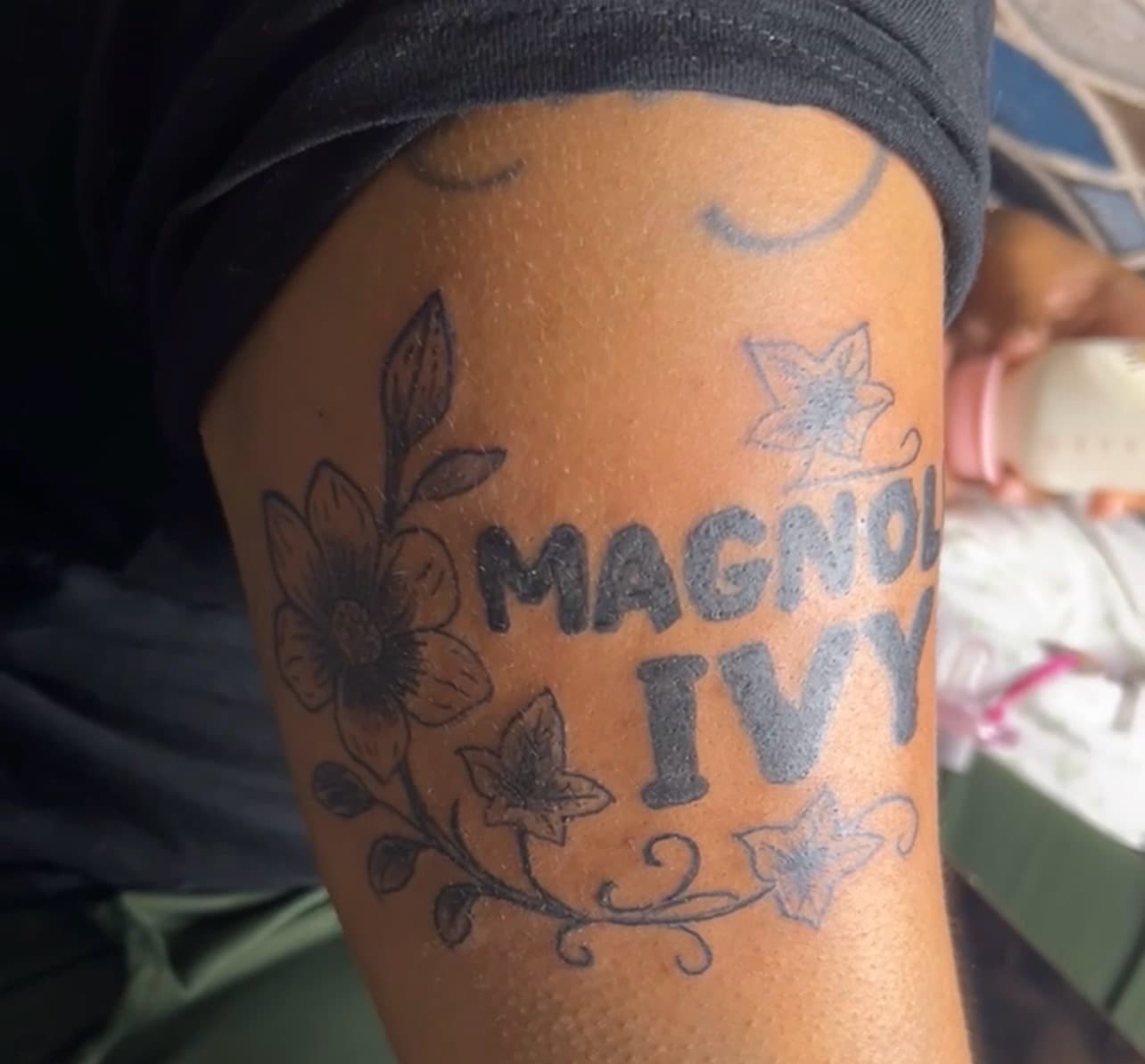 Lettering + Floral magnolia tattoo on Upper Arm by inkedbyk on TattMe
