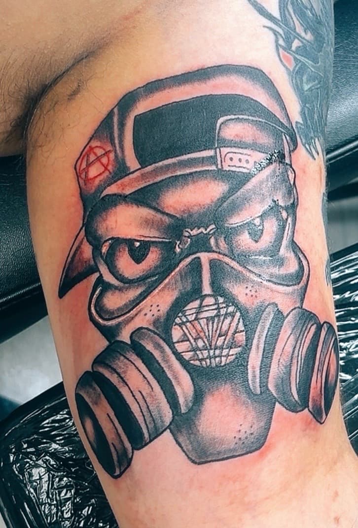 Black & Grey + Illustrative gas mask tattoo on Upper Arm by Taking_Art_2_The_Streets on TattMe