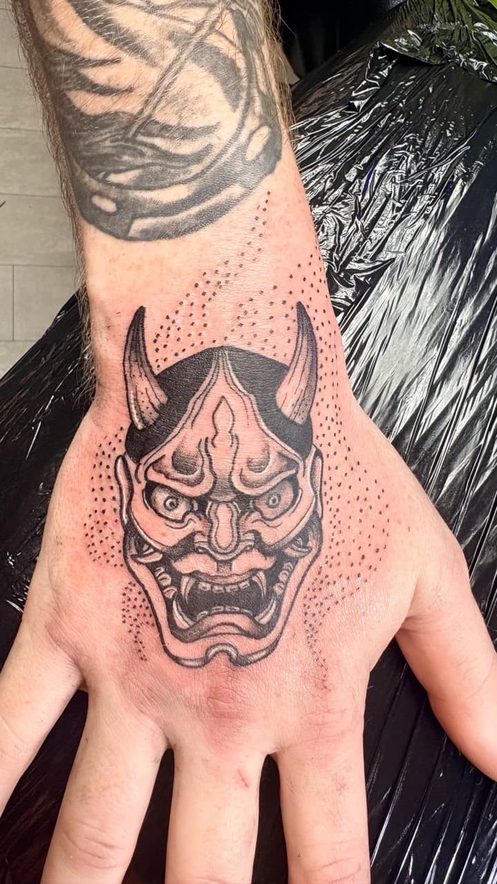 Black & Grey + Japanese hannya mask tattoo on Hand by Taking_Art_2_The_Streets on TattMe