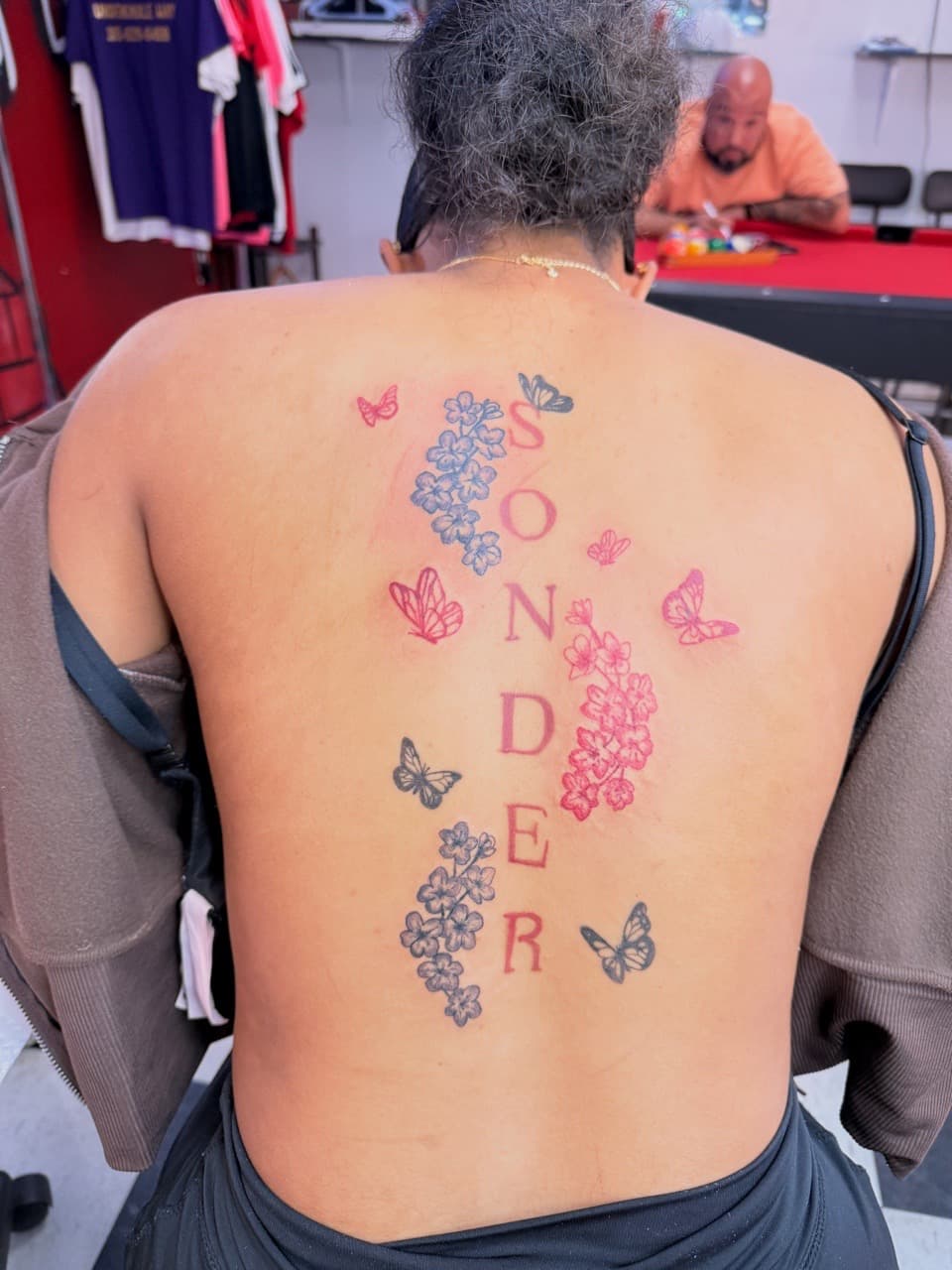 Lettering + Floral sonder tattoo on Upper Back by Lex on TattMe