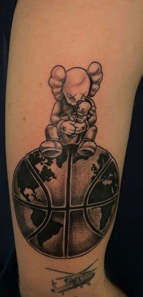 Black & Grey + Illustrative kaws tattoo on Upper Arm by KD_INKORPORATED on TattMe
