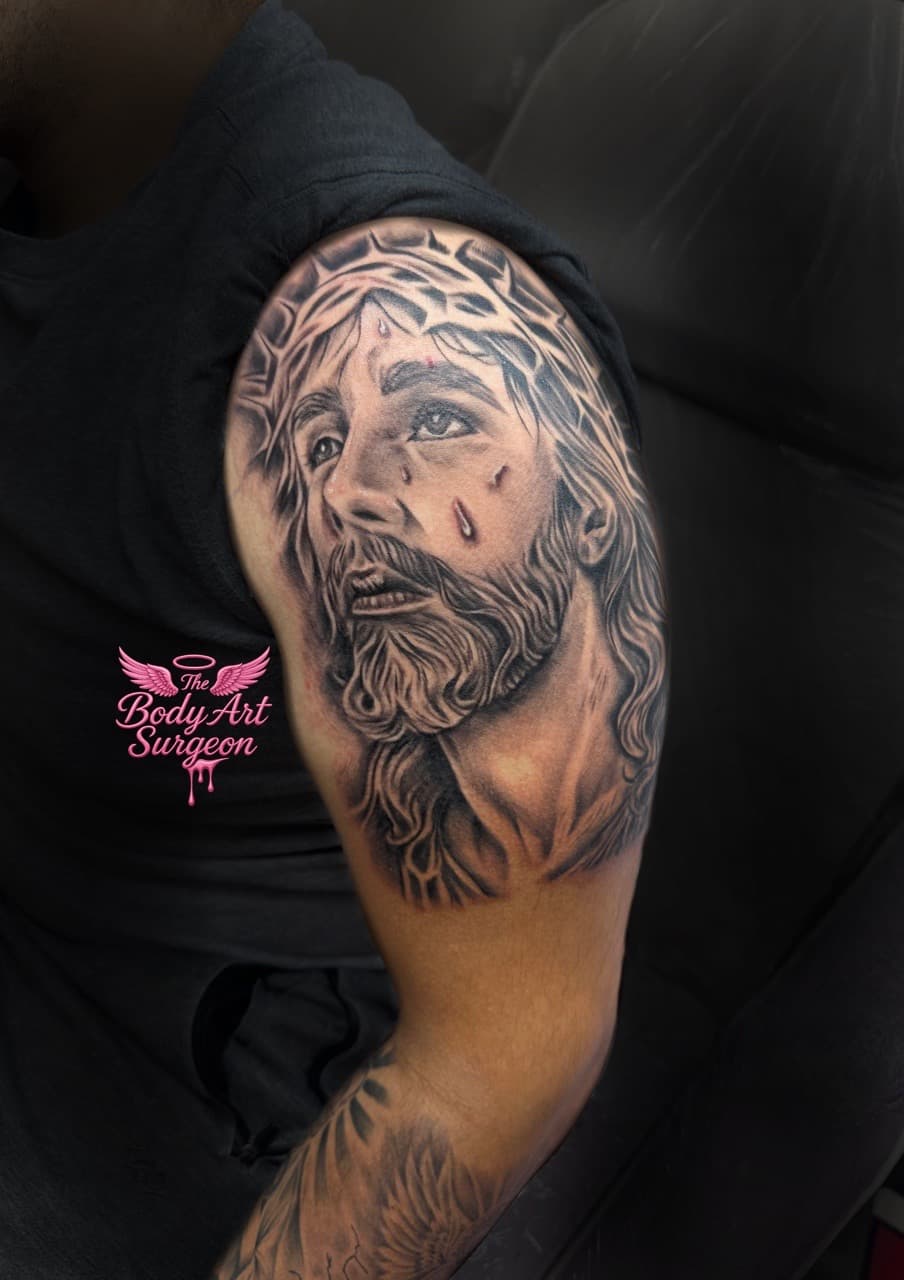 Realism + Black & Grey jesus christ tattoo on Upper Arm by The_Body_Art_Surgeon on TattMe