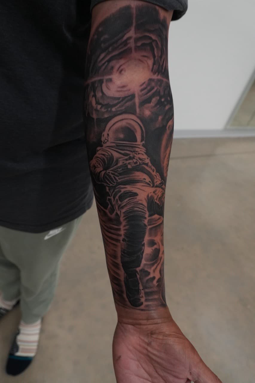 Black & Grey + Realism astronaut tattoo on Forearm by Upside_Tattoo on TattMe