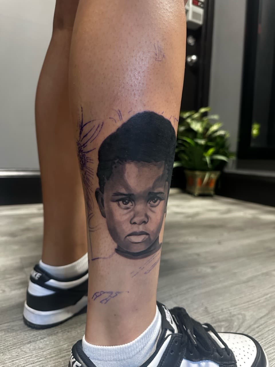 Realism + Black & Grey child tattoo on Shin by Upside_Tattoo on TattMe