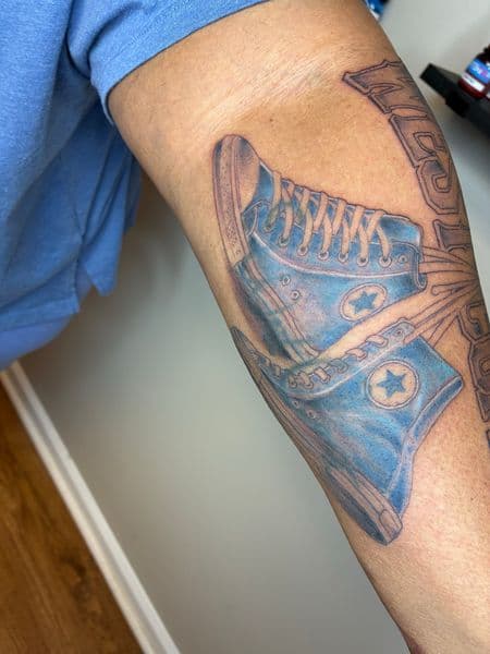 Color + Illustrative converse tattoo on Upper Arm by Bizzarreink on TattMe