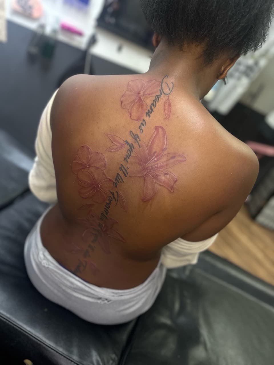 Floral + Lettering flowers tattoo on Spine by Pooh_Ink on TattMe