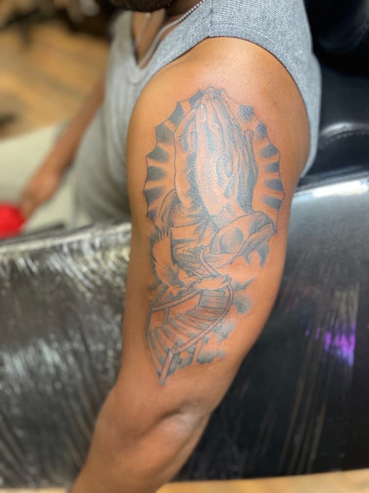 Black & Grey + Illustrative praying hands tattoo on Upper Arm by 19ktattoos on TattMe
