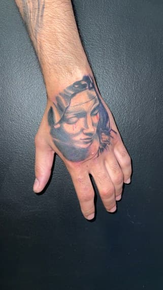 Black & Grey + Realism woman tattoo on Hand by 19ktattoos on TattMe