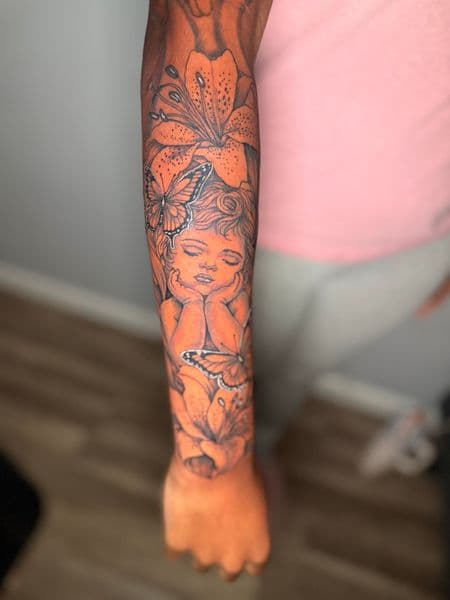 Illustrative + Floral cherub tattoo on Forearm by Edwaun_Randall on TattMe