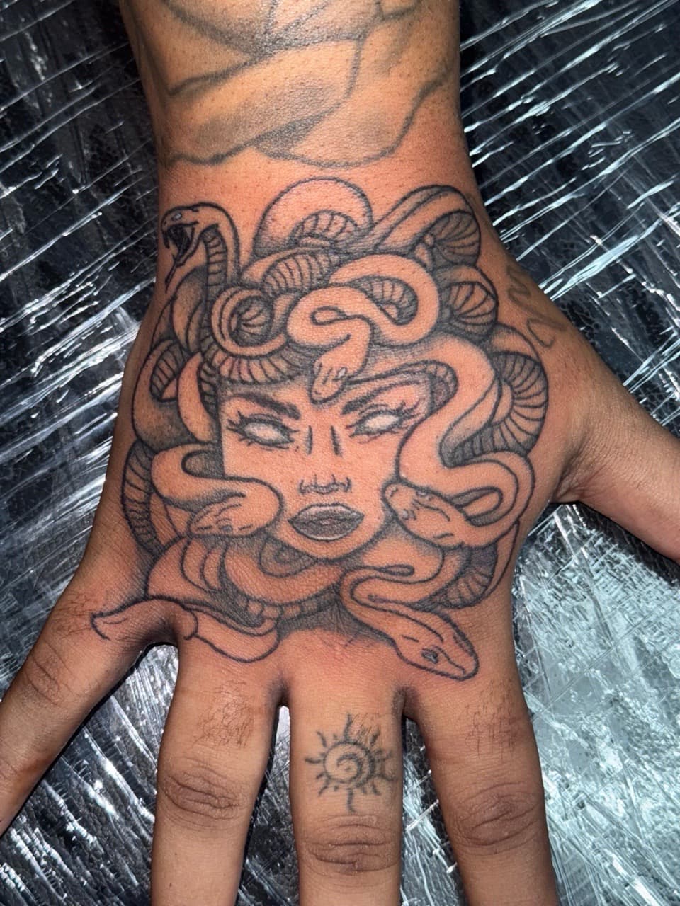 Black & Grey + Illustrative medusa tattoo on Hand by Edwaun_Randall on TattMe