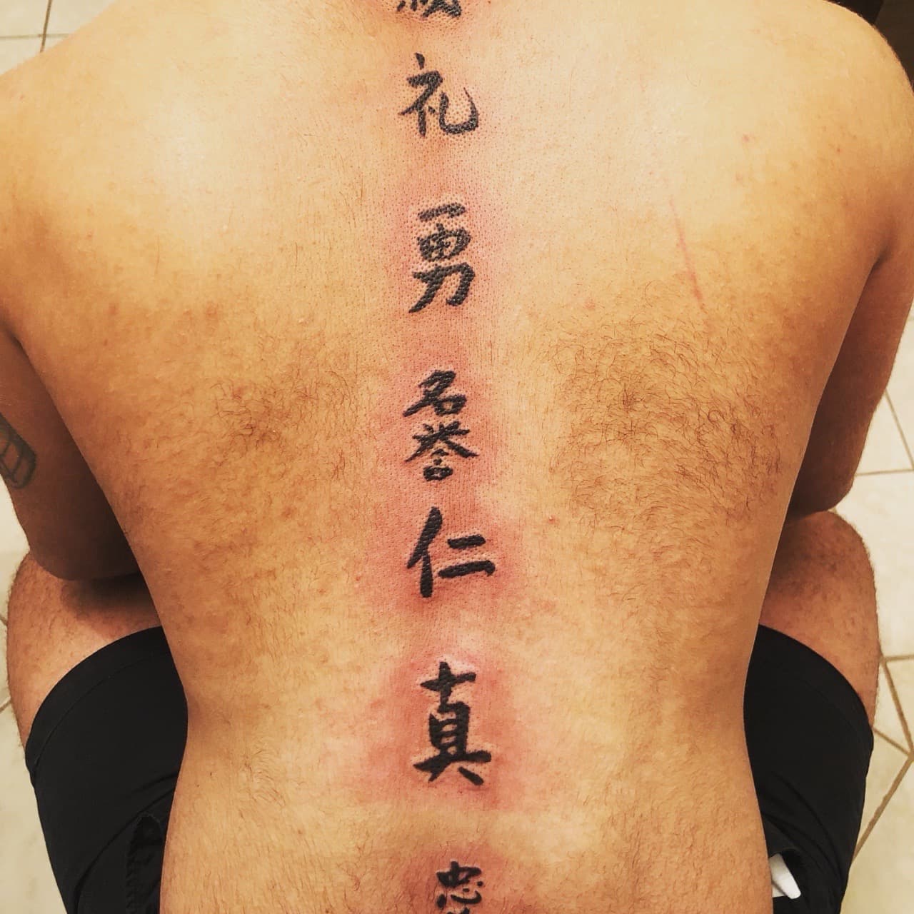 Lettering + Script characters tattoo on Spine by Mafia_Ink on TattMe