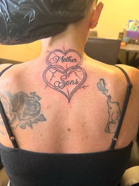 Lettering + Script hearts tattoo on Upper Back by TattsByBoogzz on TattMe