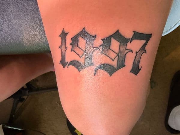 Lettering + Script numbers tattoo on Thigh by TattsByBoogzz on TattMe