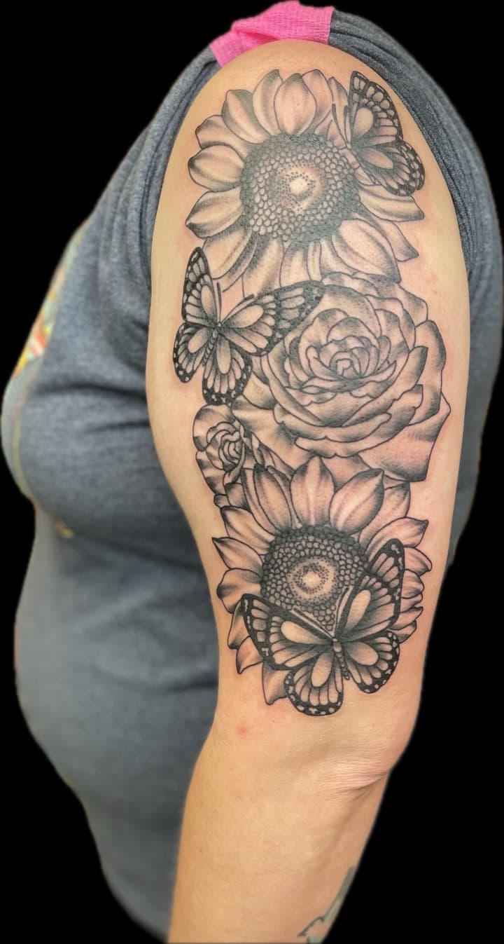 Black & Grey + Floral sunflowers tattoo on Upper Arm by Carmela_Bella on TattMe