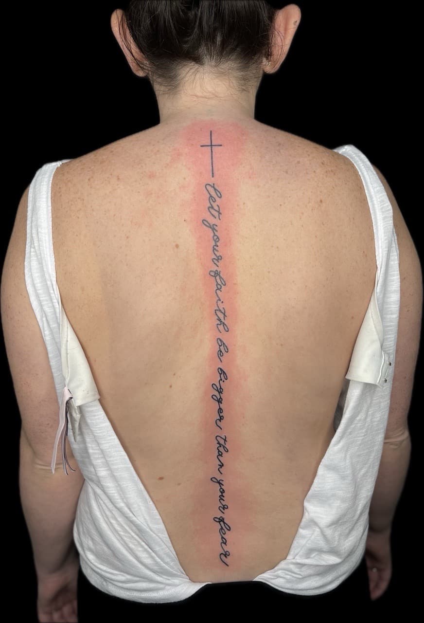 Lettering + Script cross tattoo on Spine by Carmela_Bella on TattMe
