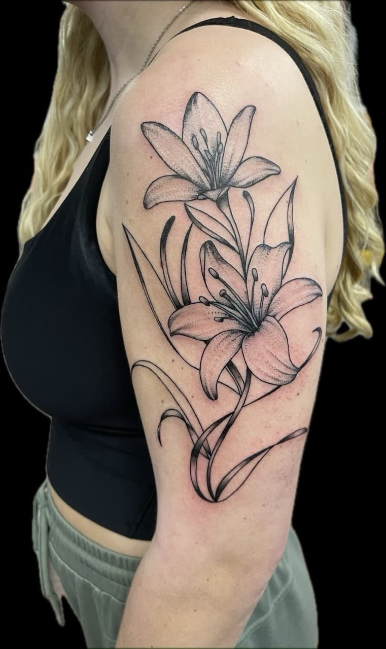 Black & Grey + Floral lilies tattoo on Upper Arm by Carmela_Bella on TattMe