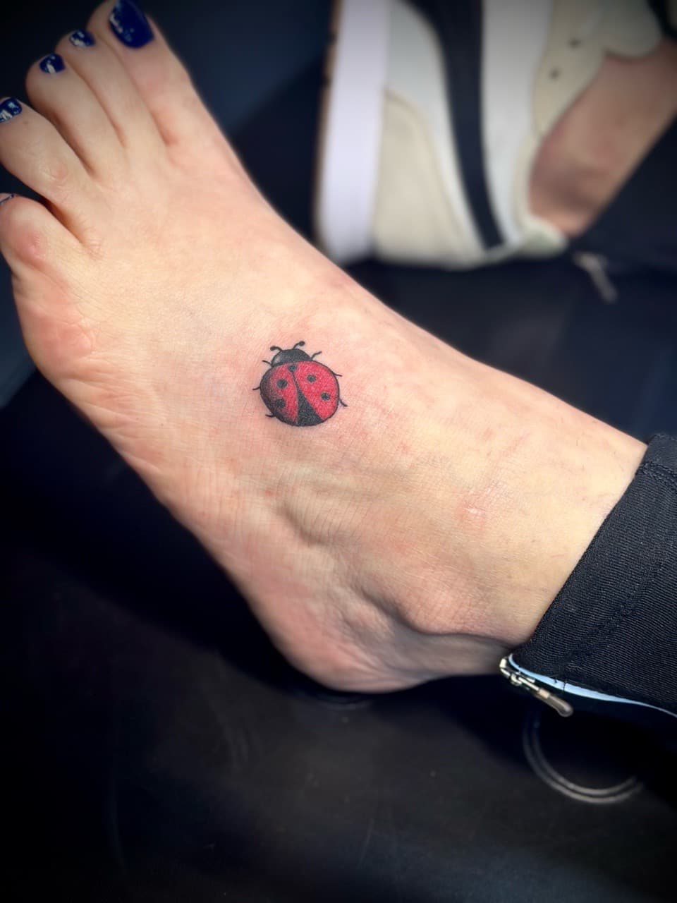 Color + Minimalist ladybug tattoo on Foot by Jr on TattMe
