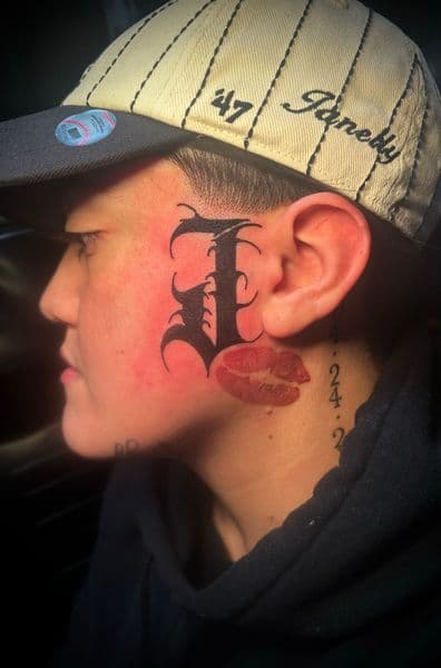 Lettering + Chicano letter tattoo on Face by Jr on TattMe