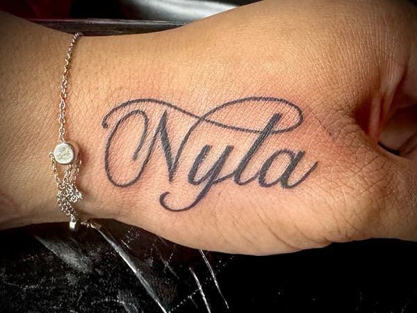 Script + Lettering name tattoo on Hand by Jr on TattMe