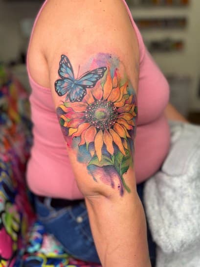 Watercolor + Color sunflower tattoo on Upper Arm by MillzyInk on TattMe