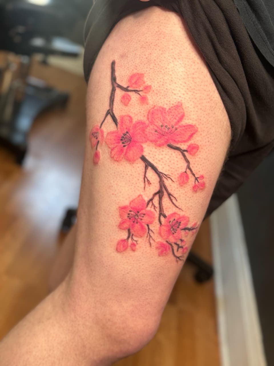 Floral + Color cherry blossoms tattoo on Thigh by KRUZ_TATTOOS on TattMe