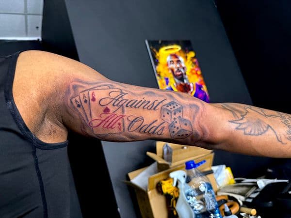 Lettering + Script playing cards tattoo on Upper Arm by JST on TattMe