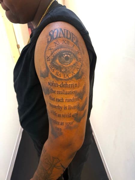 Lettering + Black & Grey eye tattoo on Upper Arm by JST on TattMe