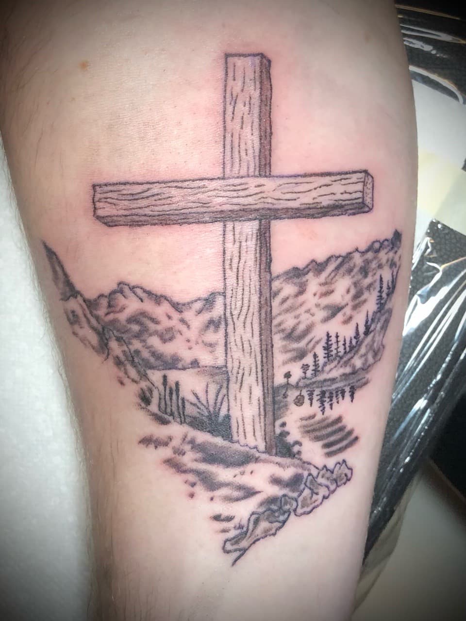 Black & Grey + Illustrative cross tattoo on Upper Arm by AdrianWareTattoos on TattMe