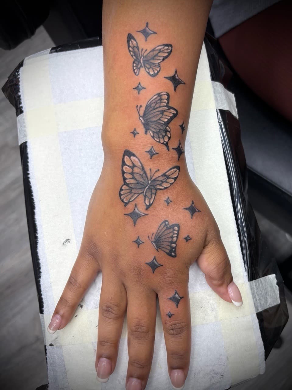 Black & Grey + Fine Line butterflies tattoo on Hand by AdrianWareTattoos on TattMe
