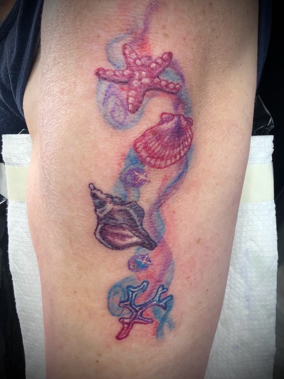 Watercolor + Color starfish tattoo on Upper Arm by AdrianWareTattoos on TattMe