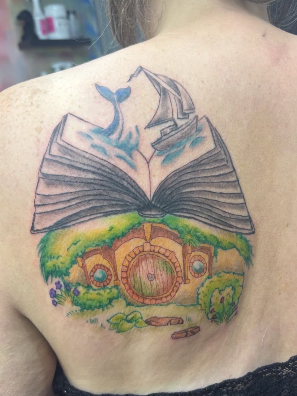 Illustrative + Color book tattoo on Upper Back by AdrianWareTattoos on TattMe