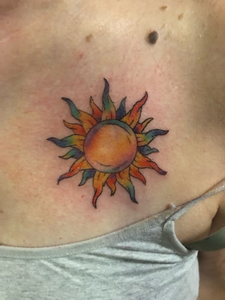 Color + Watercolor sun tattoo on Chest by AdrianWareTattoos on TattMe