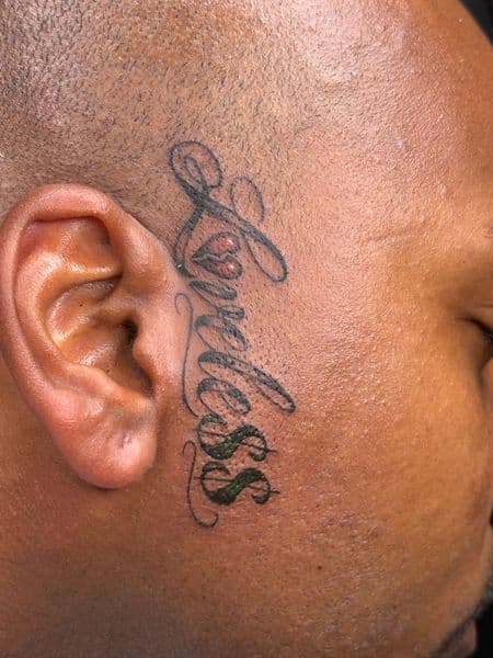 Lettering + Script lettering tattoo on Face by hippie.Inkster on TattMe