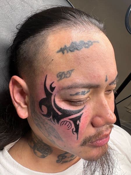 Tribal + Black-work face tattoo on Face by hippie.Inkster on TattMe