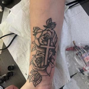 Black & Grey + Floral cross tattoo on Forearm by hippie.Inkster on TattMe