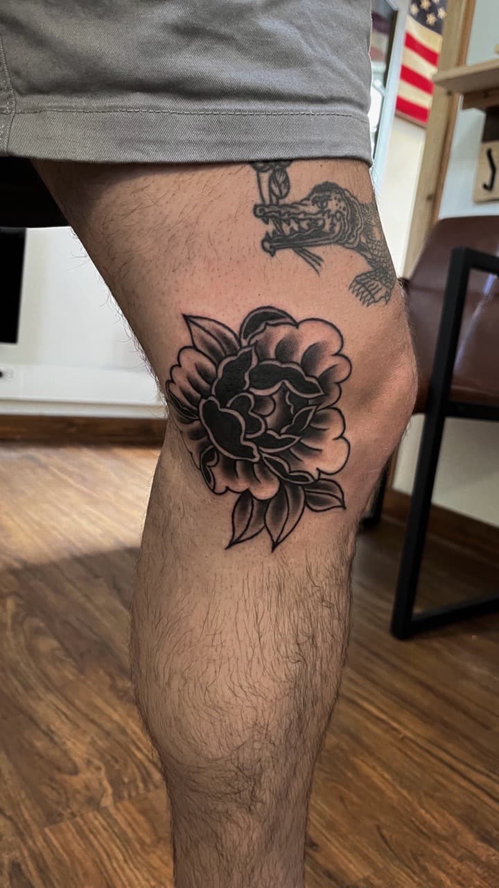 Traditional + Black & Grey flower tattoo on Knee by high_hurdle_tattoo on TattMe