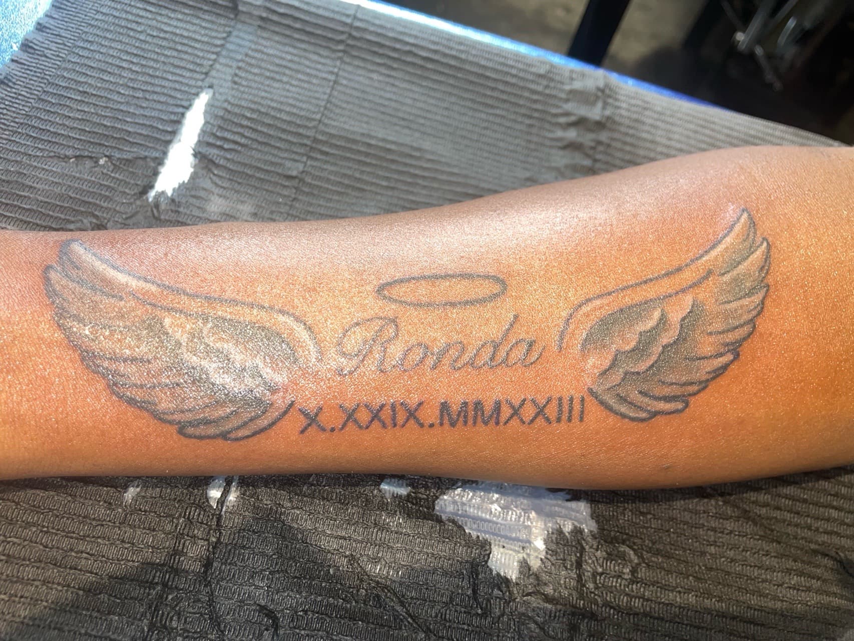 Black & Grey + Lettering wings tattoo on Forearm by InkedByKellz on TattMe
