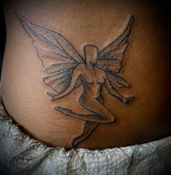 Fine Line + Black-work fairy tattoo on Lower Back by Arttrigga on TattMe