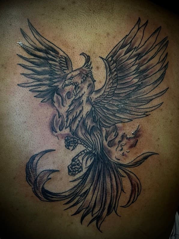 Black & Grey + Illustrative phoenix tattoo on Upper Back by Arttrigga on TattMe