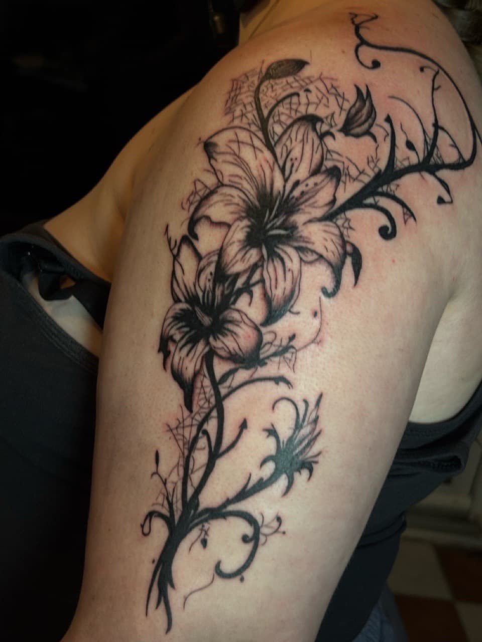 Black-work + Floral lilies tattoo on Upper Arm by inkedbyshyllc on TattMe