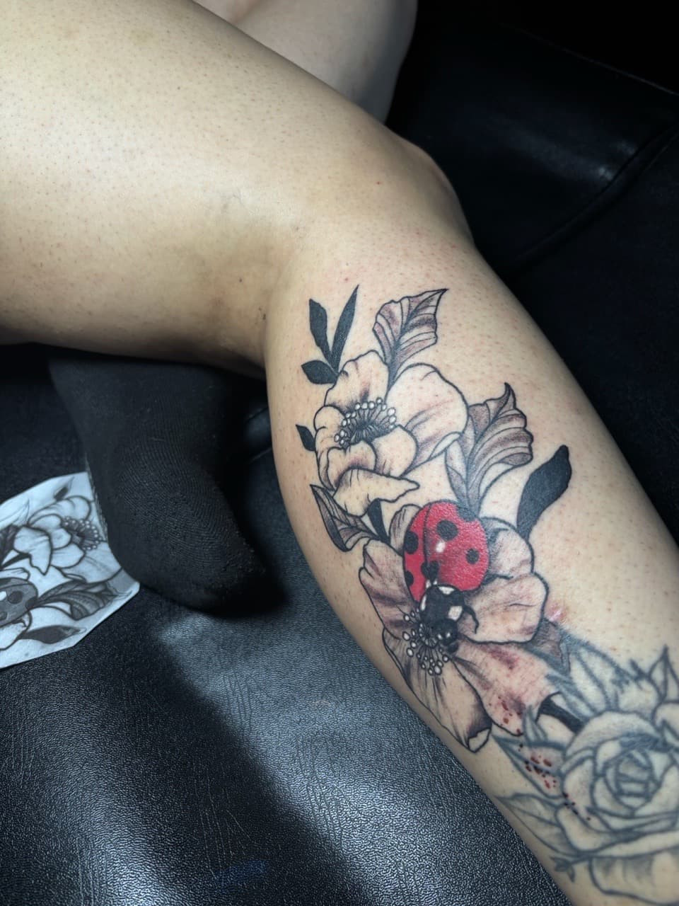 Floral + Black & Grey ladybug tattoo on Calf by inkedbyshyllc on TattMe