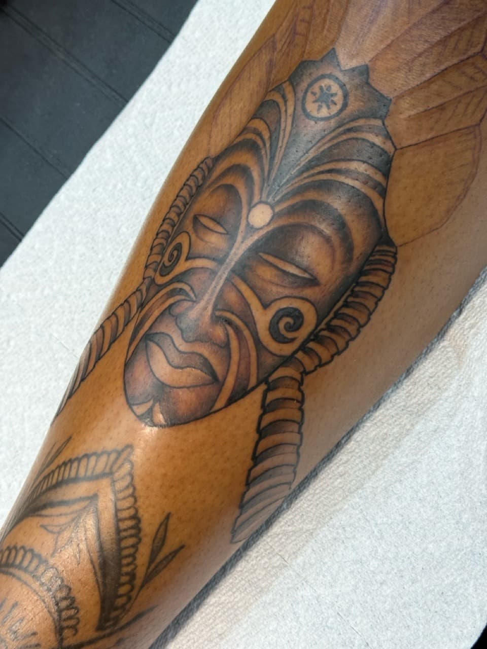 Black & Grey + Tribal mask tattoo on Calf by Ink_by_Noble on TattMe