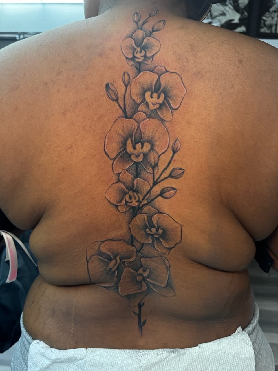Floral + Black & Grey orchids tattoo on Spine by Ink_by_Noble on TattMe
