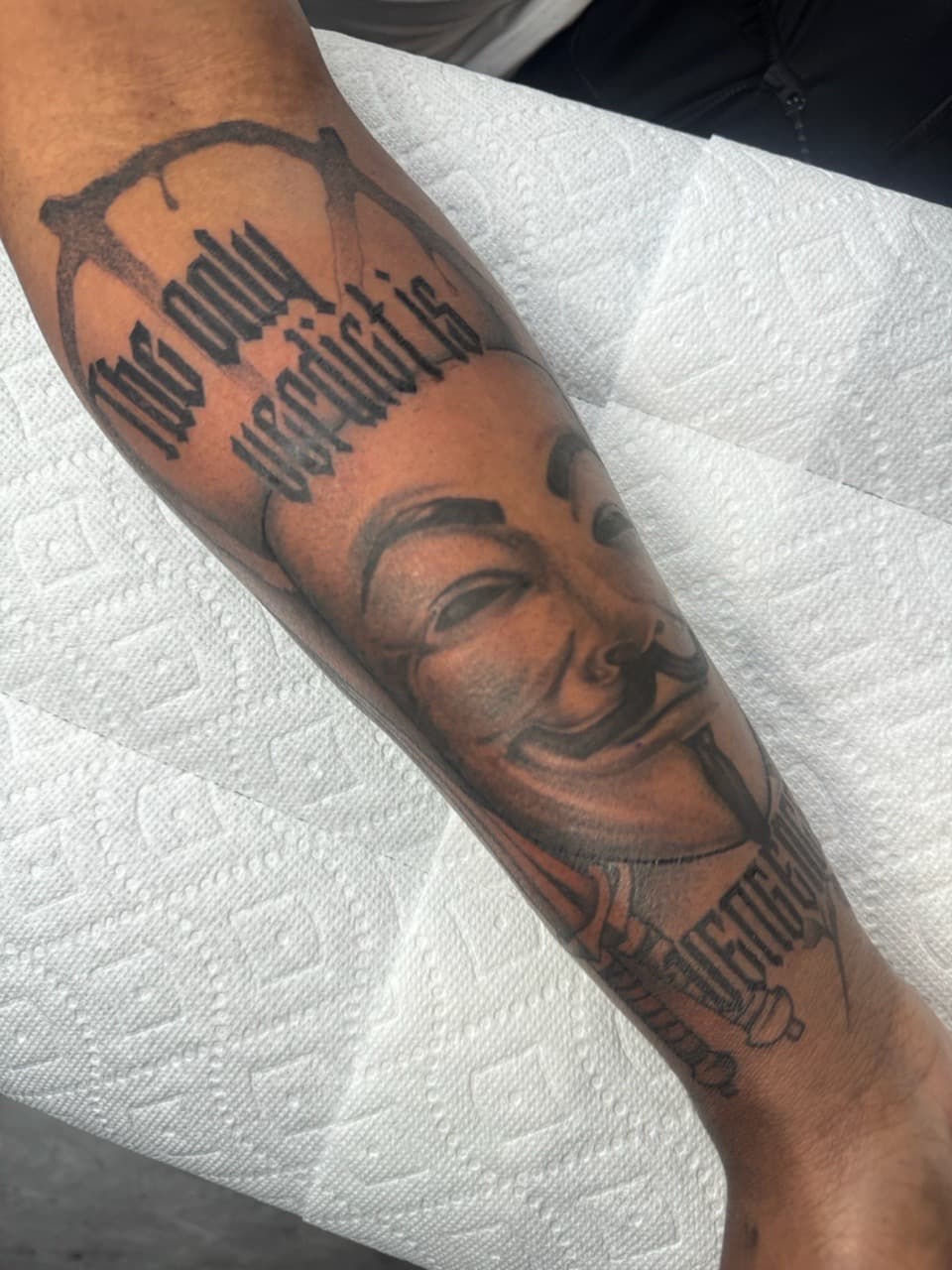 Black & Grey + Lettering mask tattoo on Forearm by Ink_by_Noble on TattMe