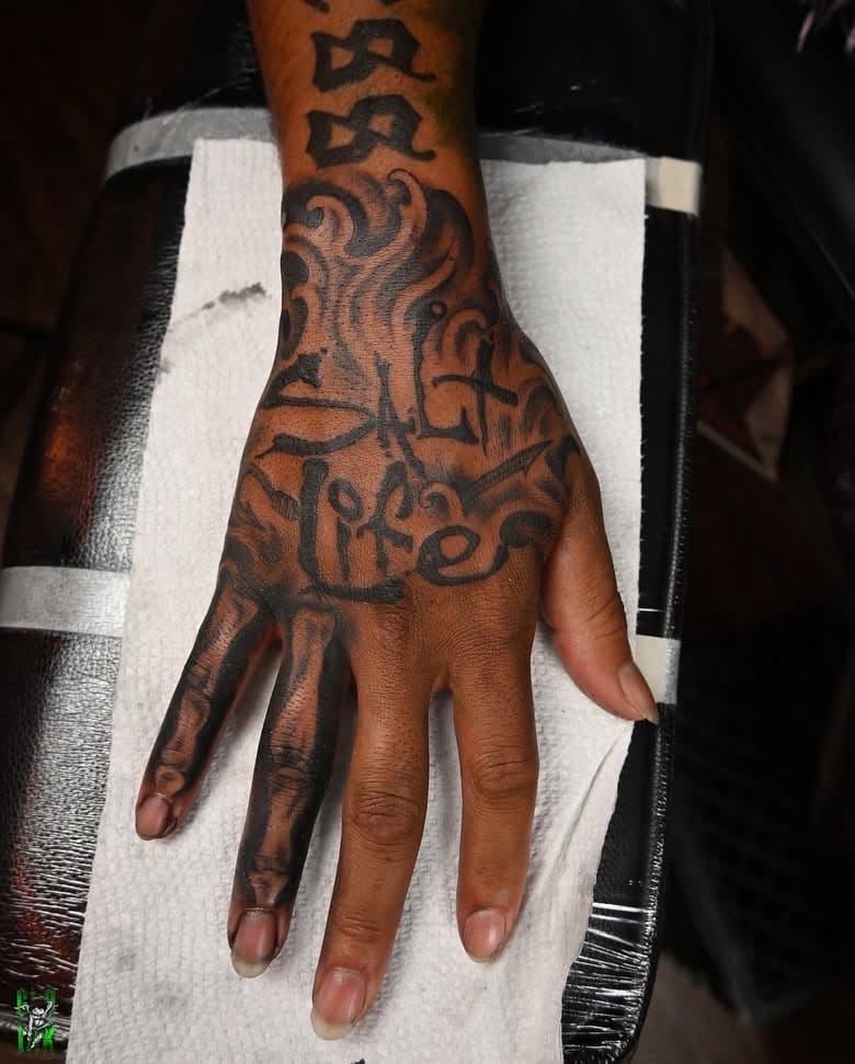 Black & Grey + Lettering word tattoo on Hand by Global_Ink_Tattoos on TattMe
