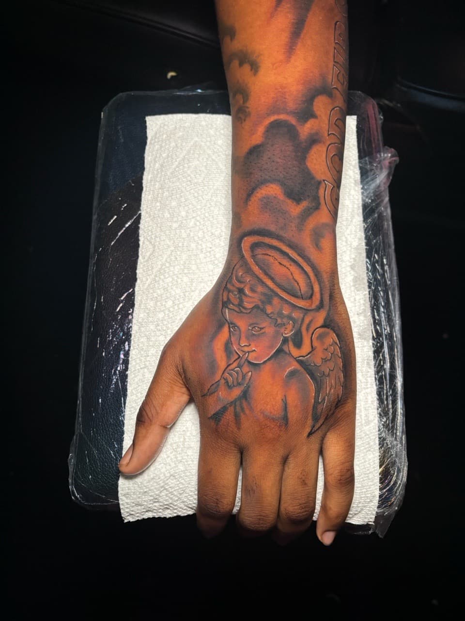 Black & Grey + Illustrative cherub tattoo on Hand by Lottooink on TattMe