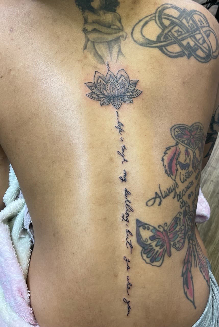Fine Line + Black-work lotus tattoo on Spine by PIKAISSO on TattMe