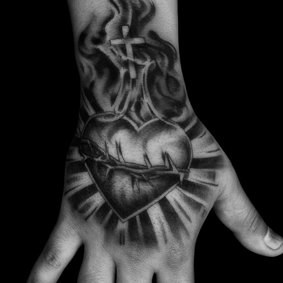 Black & Grey + Religious sacred heart tattoo on Hand by Surrender_Ink on TattMe