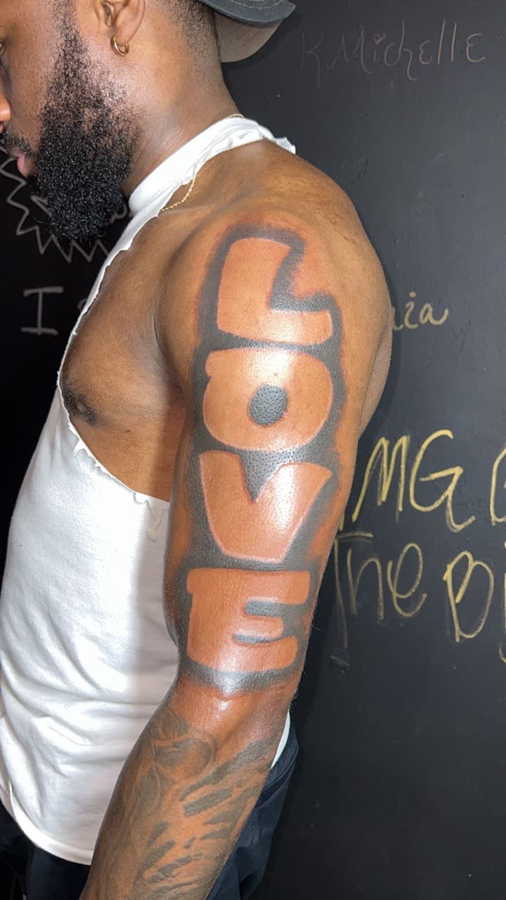 Lettering + Color love tattoo on Upper Arm by Jay on TattMe