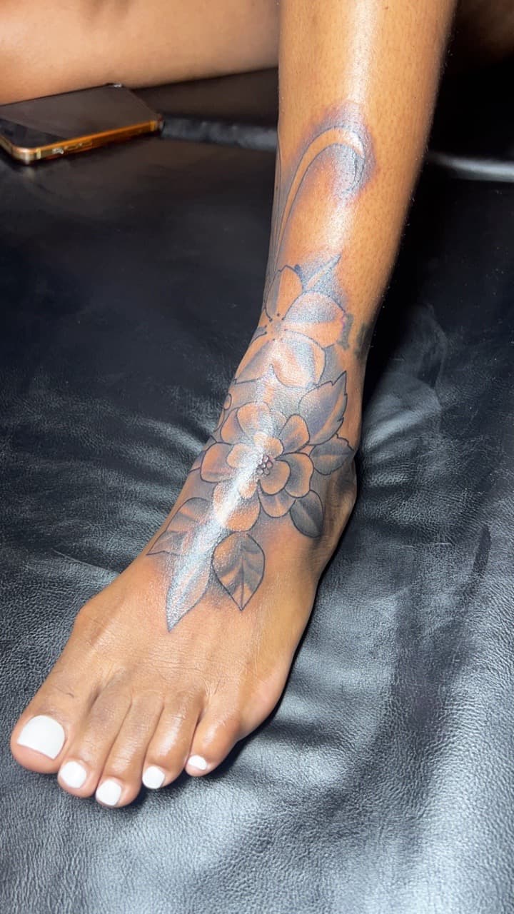 Floral + Black & Grey flowers tattoo on Foot by Jay on TattMe